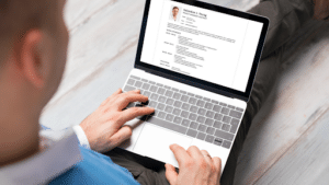 Candidate reviewing a CV on a laptop before sending it to a recruiter