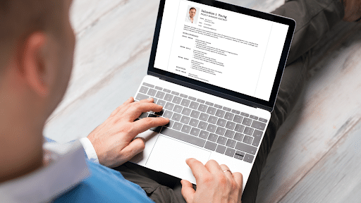 Candidate reviewing a CV on a laptop before sending it to a recruiter